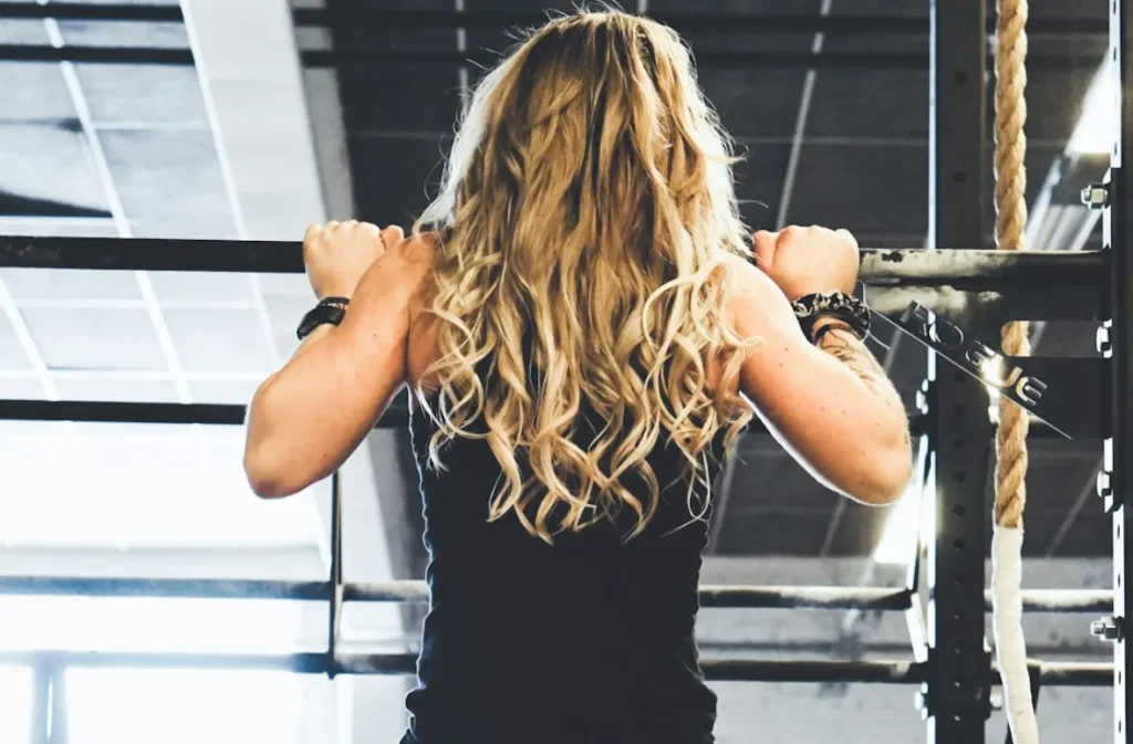 Woman doing a Tai Chi pull-up, back view.