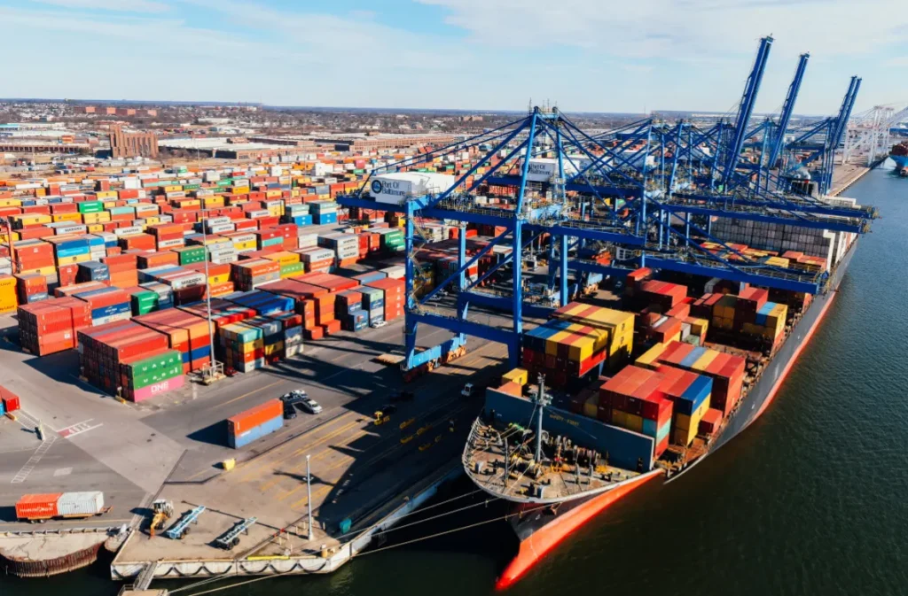 Cargo ship loaded with fire shipping containers docked.