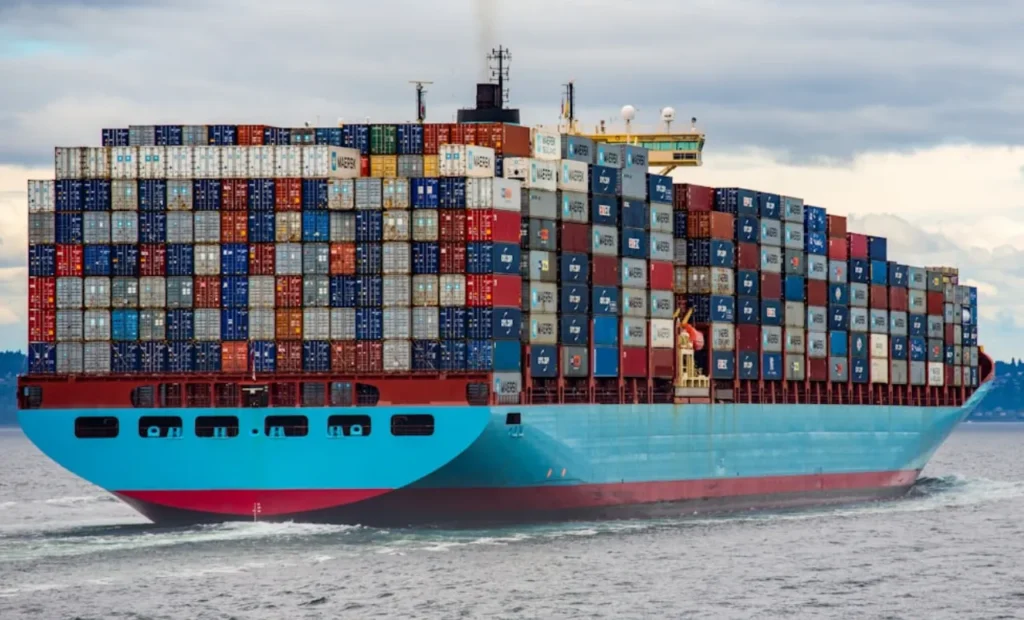 A Maersk container ship carrying colorful shipping containers.