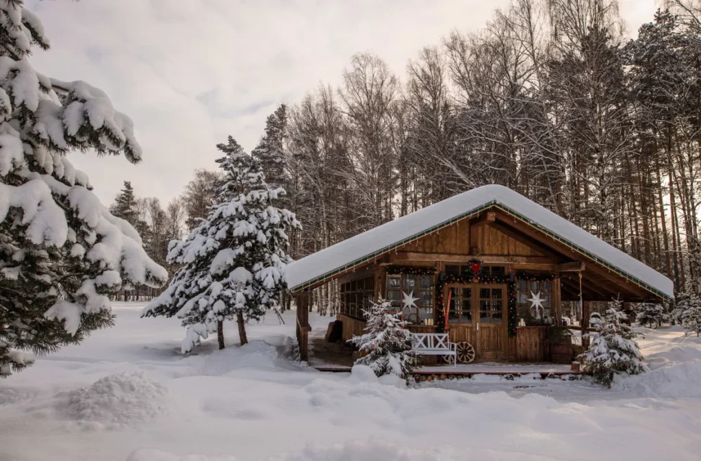 Cozy wooden shipping container cabin surrounded by snow.